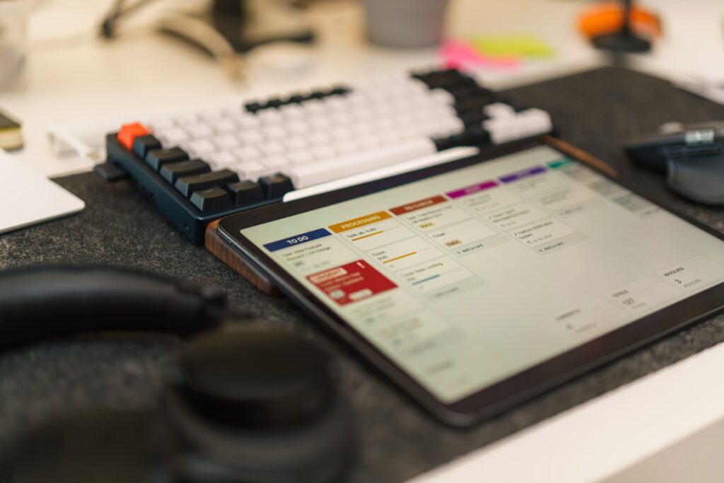 Tech-focused workspace featuring a tablet, mechanical keyboard, and productivity app for efficient task management.